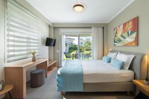 a hotel room with a bed and a balcony at Bianco Mare Studios-Apartments in Kalives Poligirou