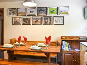 a dining room table with red napkins on it at Church House in Ulpha