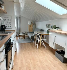 a kitchen and living room with a couch and a table at Refugium by Zirwick Apartment in Weiherhammer