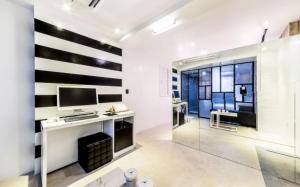 a room with a desk and a computer on a wall at Hotel Campanella in Seoul