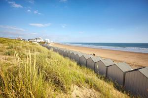 a beach with a fence on the side of it at Le Domaine des Pins in Saint-Hilaire-de-Riez