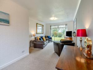 a living room with a couch and a table at The Mulberry in Lamlash