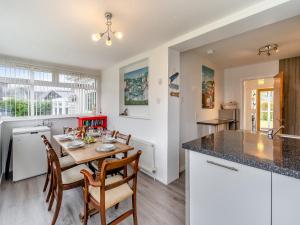 a kitchen and dining room with a table and chairs at The Mulberry in Lamlash