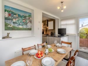 a kitchen and dining room with a table and chairs at The Mulberry in Lamlash