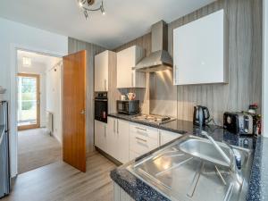 a kitchen with a sink and a counter top at The Mulberry in Lamlash +12 photos