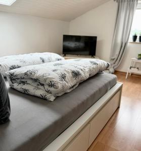 a bed with two pillows on it in a bedroom at Refugium by Zirwick Apartment in Weiherhammer