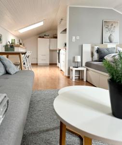 a living room with a couch and a table at Refugium by Zirwick Apartment in Weiherhammer +4 photos
