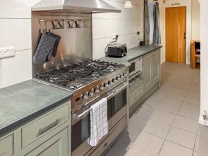 a kitchen with a large stove top oven at Wellhead Cottage in Haworth