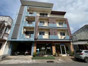 a building with a car parked in front of it at Easy Loft Hostel in Phuket