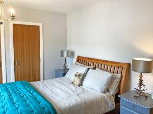 a bedroom with a teddy bear sitting on a bed at Seasgair in Dingwall