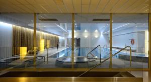 a building with a swimming pool in the middle of it at Hotel Bażantowo Sport in Katowice