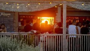 a group of people sitting at a bar at Camping A la Corniche - Maeva in Angoulins-sur-Mer