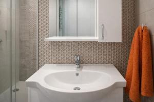 a bathroom with a white sink and a shower at Comfortable ! Stylish ! Fully Air Conditioned ! in Sannat +11 photos