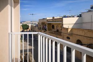 a view of a city from a balcony at Comfortable ! Stylish ! Fully Air Conditioned ! in Sannat
