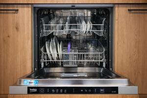 a dishwasher with dishes inside of it at Comfortable ! Stylish ! Fully Air Conditioned ! in Sannat