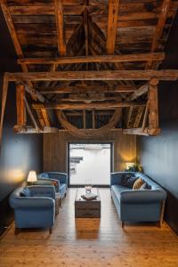a living room with two blue couches and a table at Kuringen Brygge Hotel and Restaurant in Refsnes +14 photos