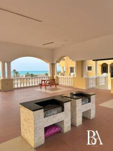a large living room with a stone fireplace and the ocean at Bel Air -- Sea View Studio in Ras al Khaimah