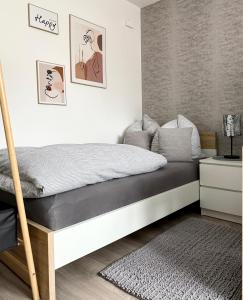 a bedroom with a bed with a black and white mattress at Solo by Zirwick Apartment in Weiherhammer