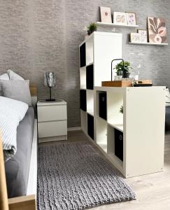a bedroom with a white cabinet and a bed at Solo by Zirwick Apartment in Weiherhammer +5 photos