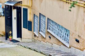 a building with blue shuttered windows on the side of it at Talenti Suites Rome Casa Vacanze in Rome