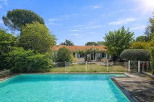 a swimming pool in front of a house at Villa Lanaka in Grabels