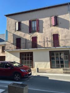 a red car parked in front of a building at Carpe Diem 2 in Goutrens