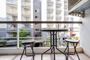 a balcony with a table and two stools at Hua Hin Condo A - Maysa & Hin Nam in Hua Hin