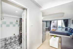 a living room with a couch and a bed at Hua Hin Condo A - Maysa & Hin Nam in Hua Hin