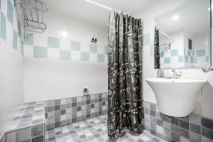 a bathroom with a sink and a shower curtain at Hua Hin Condo A - Maysa & Hin Nam in Hua Hin