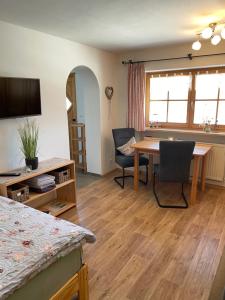 a room with a table and chairs and a dining room at Apartment Rothenlehen in Bischofswiesen