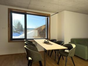 a room with a table and chairs and a window at Apartmán Ore&Moor in Boží Dar