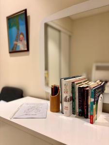 a desk with books on it with a mirror at Sifa Golf & Beach Escape in As Sīfah