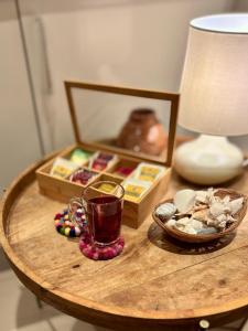 a table with a cup of tea and a picture on it at Sifa Golf & Beach Escape in As Sīfah +6 photos