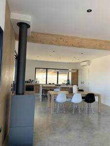 a living room with a fireplace and a table and chairs at Villa Al Fianco in Petacciato