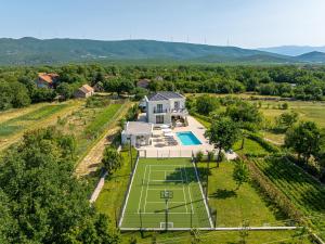 an aerial view of a house with a tennis court at Villa Decima near Split - Heated Pool, Tennis Court & Billiards in Dicmo