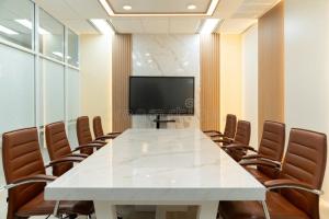 a conference room with a large white table and chairs at Cityscape And Retreat Hotel in Mbeya