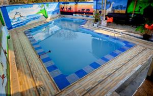 a large swimming pool with a painting on the wall at Cityscape And Retreat Hotel in Mbeya
