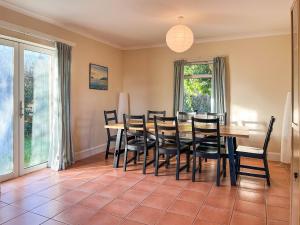 a dining room with a table and chairs at Holly Croft in Drem