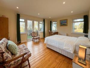 a bedroom with a bed and a living room at Holly Croft in Drem +9 photos
