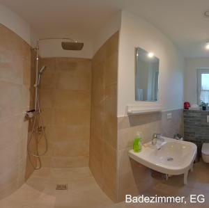 a bathroom with a shower and a sink and a toilet at Ferienhaus Sonne in Göhren-Lebbin +20 photos