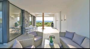 a living room with a couch and a table at Palme Luxury Villa in Galatás