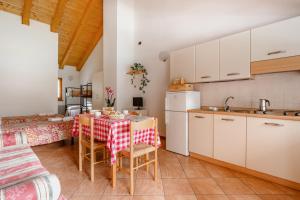 a kitchen and dining room with a table and chairs at Sarca Lodge Val Rendena in Dare