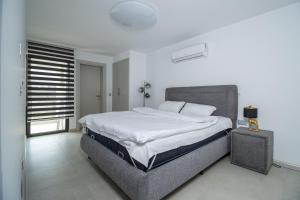 a bedroom with a large bed and a window at Mykonos Holiday Homes in Kyrenia +71 photos