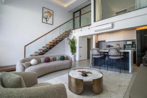 a living room with a couch and a table at Mykonos Holiday Homes in Kyrenia