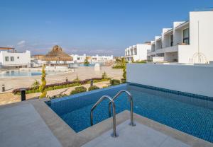 a view of a swimming pool in a building at Mykonos Holiday Homes in Kyrenia