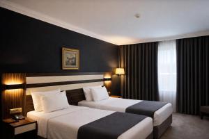 a hotel room with two beds and a window at Akgün Hotel Laleli Istanbul in Istanbul +23 photos