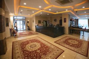 a lobby with two large rugs on the floor and a bar at Akgün Hotel Laleli Istanbul in Istanbul