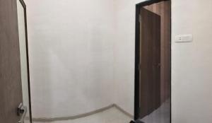 an open door to a bathroom with a mirror at Mannat Bungalow in Amrāvati +4 photos