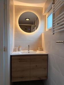 a bathroom with a sink and a mirror at Beach House Sea-Esta in Egmond aan Zee +66 photos