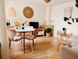 a living room with a table and chairs at Beach House Sea-Esta in Egmond aan Zee